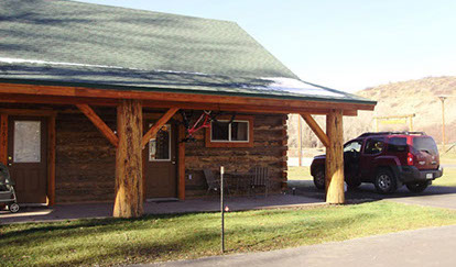 Photos Page or Gallery, outside Side view of cabin with a car next to it